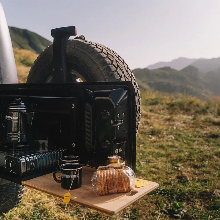 Drop Down Tailgate Table: tailgate table set up for coffee at camp